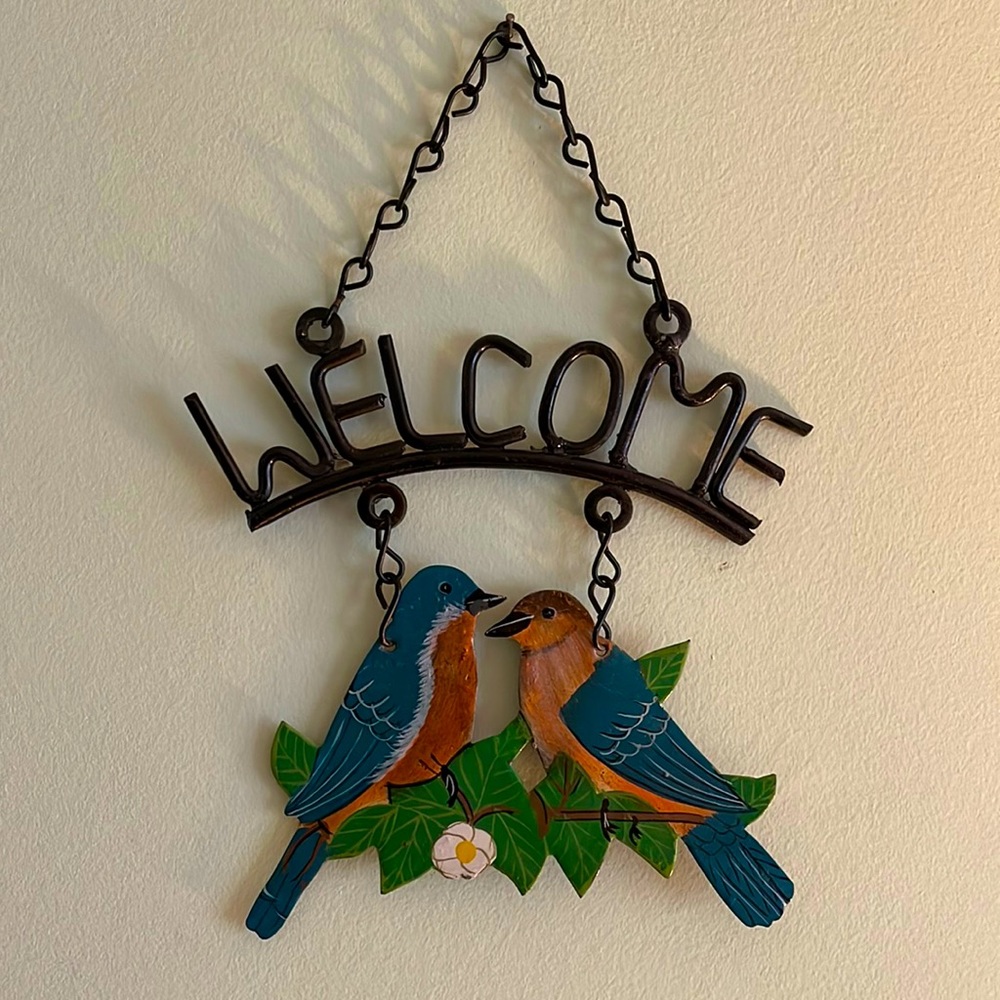 Vintage metal “Welcome” sign with birds